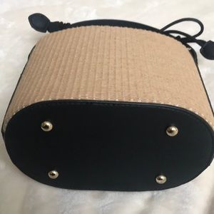 Brand new summer hand bag tan straw and black handle and trim.